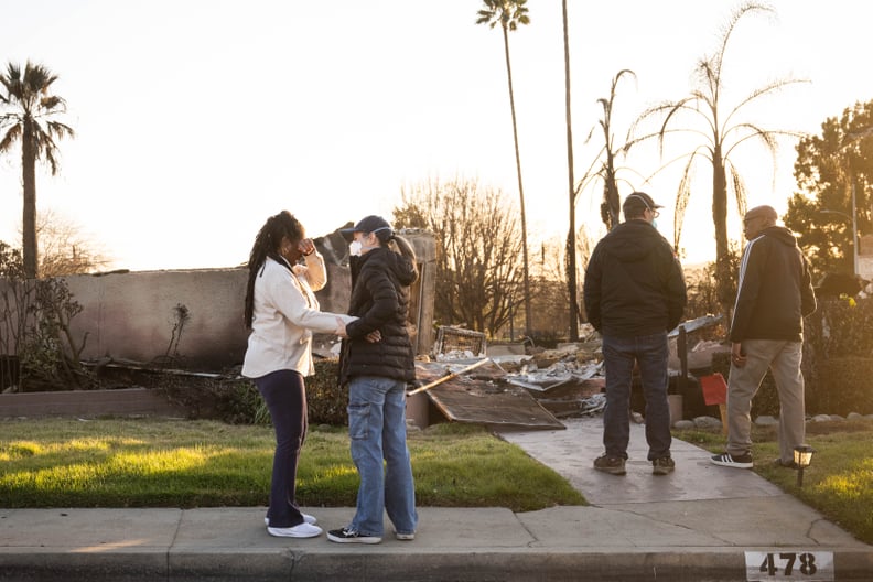 Altadena, CA - January 20:Dina Villani comforts Elaine Emerson as she returns to her Altadena neighborhood and finds her home in ashes on Monday, January 20, 2025 as their husbands Pete Villani and Jarvis Emerson talk. The neighbors said they use to wave